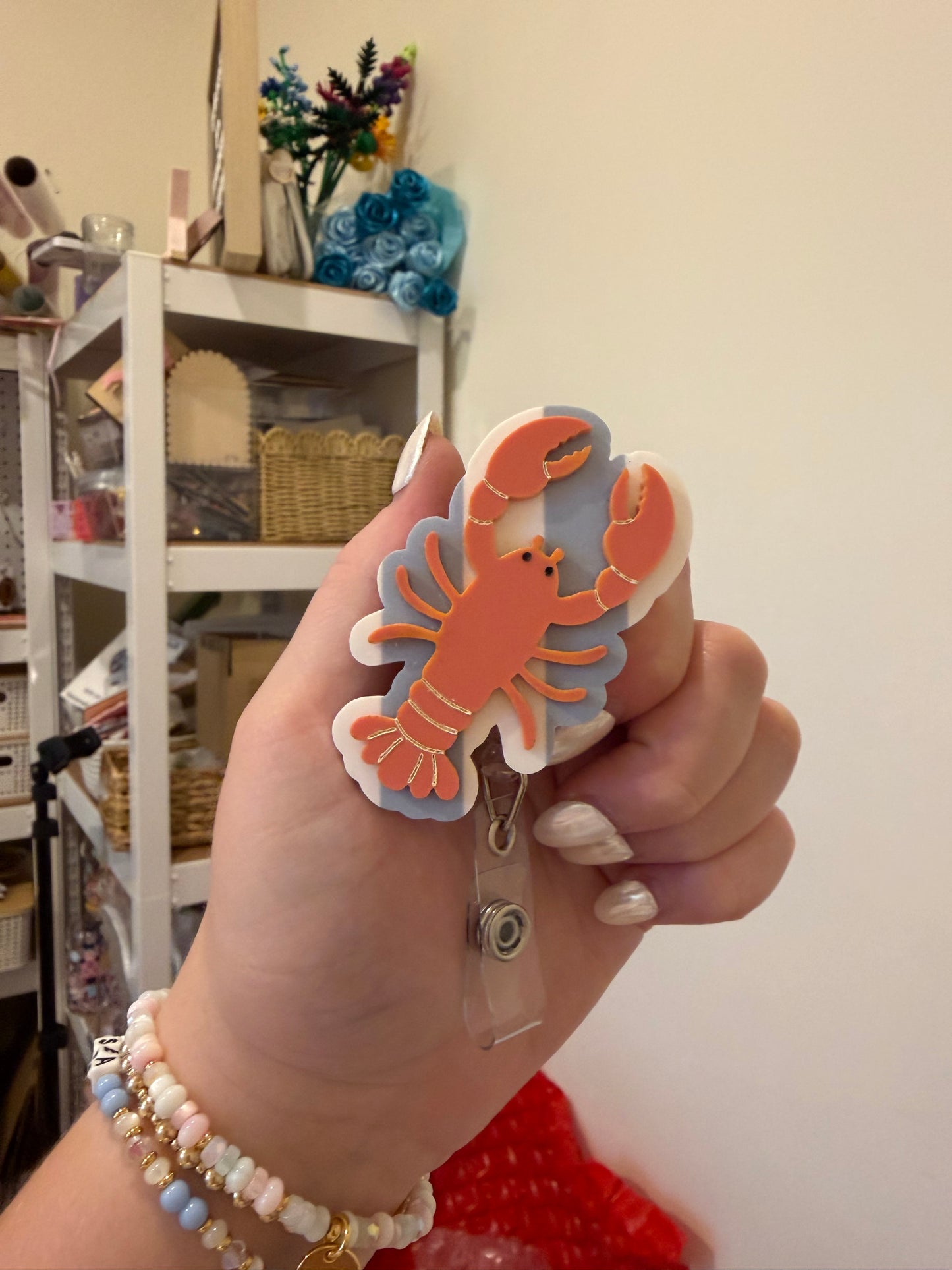 Lobster with Striped Background Badge Reel